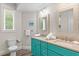Bathroom with teal double vanity and walk-in shower at 106 7Th S St, Bradenton Beach, FL 34217