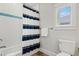 Bathroom with tub shower, striped shower curtain, and window at 106 7Th S St, Bradenton Beach, FL 34217