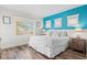 King bedroom with a teal accent wall and wood floors at 106 7Th S St, Bradenton Beach, FL 34217