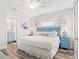 King-size bed in bedroom with en-suite bath at 106 7Th S St, Bradenton Beach, FL 34217