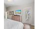 Main bedroom with large TV, dresser, and private balcony access at 106 7Th S St, Bradenton Beach, FL 34217