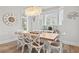 Elegant dining room featuring a rustic wooden table and white chairs at 106 7Th S St, Bradenton Beach, FL 34217