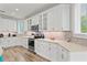 Bright kitchen with white cabinets, stainless steel appliances, and light-colored countertops at 106 7Th S St, Bradenton Beach, FL 34217
