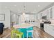 Modern kitchen with a teal island and white cabinets at 106 7Th S St, Bradenton Beach, FL 34217