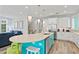 Modern kitchen with a teal island and white cabinets at 106 7Th S St, Bradenton Beach, FL 34217