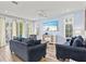 Spacious living room with comfortable sofas, hardwood floors, and a large TV at 106 7Th S St, Bradenton Beach, FL 34217