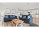 Living room with blue sofas and view of kitchen at 106 7Th S St, Bradenton Beach, FL 34217
