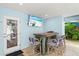 Outdoor patio bar with seating and a large TV at 106 7Th S St, Bradenton Beach, FL 34217