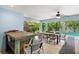 Pool area with covered patio, dining table, and pool at 106 7Th S St, Bradenton Beach, FL 34217