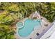 Inviting freeform pool with spa and waterslide, surrounded by lush landscaping at 106 7Th S St, Bradenton Beach, FL 34217