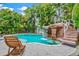 Inviting pool area with waterfall, spa, and lounge chair at 106 7Th S St, Bradenton Beach, FL 34217