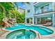 Large pool with a waterslide, spa, and patio furniture at 106 7Th S St, Bradenton Beach, FL 34217