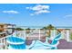 Rooftop deck with ocean view and two blue chairs at 106 7Th S St, Bradenton Beach, FL 34217