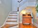 Elegant wooden staircase with a classic wooden railing and antique secretary at 108 17Th E St, Bradenton, FL 34208