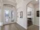 Bright entryway with double doors, hardwood floors & office view at 10817 Whisk Fern Dr, Venice, FL 34293