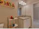 Well-lit bathroom, granite vanity, and tiled shower at 13816 Messina Loop # 203, Bradenton, FL 34211