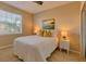 Cozy bedroom with a queen bed and golf course art at 13816 Messina Loop # 203, Bradenton, FL 34211