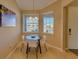 Bright breakfast nook with a round table and four white chairs at 13816 Messina Loop # 203, Bradenton, FL 34211
