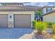 Exterior view of a two-story condo with a two-car garage and landscaped grounds at 13816 Messina Loop # 203, Bradenton, FL 34211