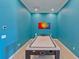 Fun game room with air hockey table and vibrant blue walls at 13816 Messina Loop # 203, Bradenton, FL 34211
