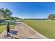Landscaped walking path alongside a golf course with a lake in the distance at 13816 Messina Loop # 203, Bradenton, FL 34211