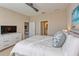 Spacious main bedroom with a large TV and ensuite bathroom at 13816 Messina Loop # 203, Bradenton, FL 34211