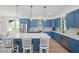 Modern kitchen featuring blue cabinetry, white countertops, and an island at 1647 Siesta Dr, Sarasota, FL 34239