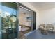 Balcony with wicker chairs and a view into the living room at 1703 N Tamiami Trl # 210, Sarasota, FL 34234