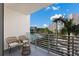Balcony with wicker chairs and a view of the community pool at 1703 N Tamiami Trl # 210, Sarasota, FL 34234