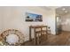 Small dining area with wooden table and bench, adjacent to kitchen at 1703 N Tamiami Trl # 210, Sarasota, FL 34234