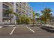 Modern multi-unit building with ample parking and tropical landscaping at 1703 N Tamiami Trl # 210, Sarasota, FL 34234