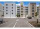 Modern building exterior with parking and landscaped areas at 1703 N Tamiami Trl # 210, Sarasota, FL 34234