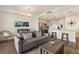 Open concept living room with grey couch and kitchen visible at 1703 N Tamiami Trl # 210, Sarasota, FL 34234