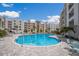 Community pool with surrounding patio furniture at 1703 N Tamiami Trl # 210, Sarasota, FL 34234