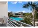 Community pool and clubhouse with palm trees at 1703 N Tamiami Trl # 210, Sarasota, FL 34234