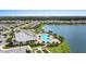 Community aerial view showcasing a pool, clubhouse, lake, and lush landscaping at 17335 Polo Trl, Bradenton, FL 34211