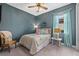 Charming bedroom featuring coastal-themed decor, a comfortable bed, and natural light from the window at 17335 Polo Trl, Bradenton, FL 34211
