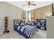 A nautical themed bedroom with a striped bed, a TV, and storage shelves at 17335 Polo Trl, Bradenton, FL 34211