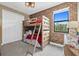 Cozy bedroom featuring a wooden bunk bed, exposed brick wall, and natural light at 17335 Polo Trl, Bradenton, FL 34211