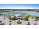 Stunning aerial view of the clubhouse, complete with a circular driveway, lush landscaping, and a serene lake backdrop at 17335 Polo Trl, Bradenton, FL 34211