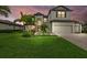 Beautiful two-story home with manicured lawn, a two-car garage, and lush tropical landscaping at 17335 Polo Trl, Bradenton, FL 34211