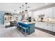Bright kitchen boasts granite countertops, stainless appliances, white cabinets, and a center island with bar stool seating at 17335 Polo Trl, Bradenton, FL 34211