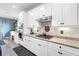 Modern kitchen features white cabinets, granite countertops, stainless appliances, and a decorative white brick backsplash at 17335 Polo Trl, Bradenton, FL 34211