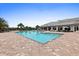 Beautiful pool area with ample seating, lush landscaping, and a well-maintained clubhouse, perfect for relaxation at 17335 Polo Trl, Bradenton, FL 34211