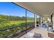 Screened patio with multiple seating areas and a grill at 17335 Polo Trl, Bradenton, FL 34211