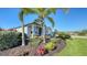 Landscaped front yard with tropical plants and lush grass at 1825 Twin Rivers Trl, Parrish, FL 34219