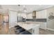 Modern kitchen with white cabinets, quartz countertops, and island at 1825 Twin Rivers Trl, Parrish, FL 34219