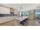 Modern kitchen with white cabinets, quartz countertops and island at 1825 Twin Rivers Trl, Parrish, FL 34219