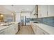 Bright kitchen with white cabinets and stainless steel appliances at 1825 Twin Rivers Trl, Parrish, FL 34219