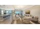 Spacious living room with hardwood floors, comfortable seating, and large TV at 1825 Twin Rivers Trl, Parrish, FL 34219